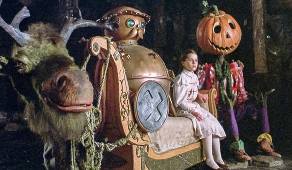 An image from the film Return to Oz features from left to right: The Gump, while Tik-Tok and Dorothy sit on a couch, and Jack Pumpkinhead at the end.