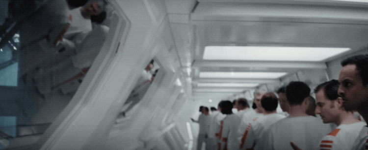 A gif I made from the Star Wars series Andor featuring the prison bridges. One prisoner is using a form of sign language to communicate with another in another far off bridge. The inside of the bridges are stark white and all inmates wear a white top and pants with a thick orange stripe down the sides.