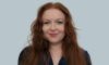 A photo of myself from the chest up I took for my LinkedIn profile. I'm a white woman with long red hair, in full makeup.